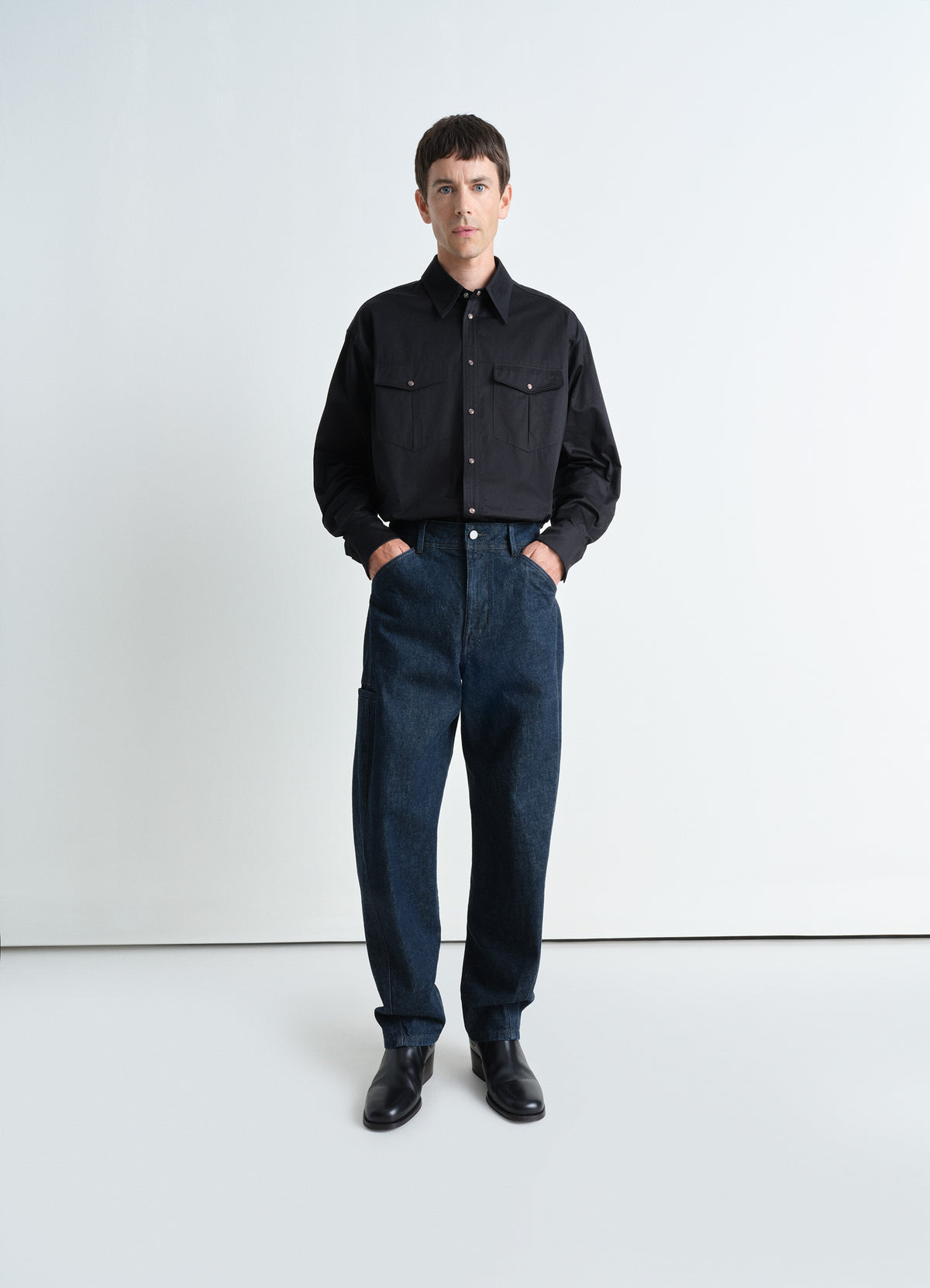 Twisted Workwear Pants in Deep Indigo Heavy Denim, model shot, Front view Twisted side seams