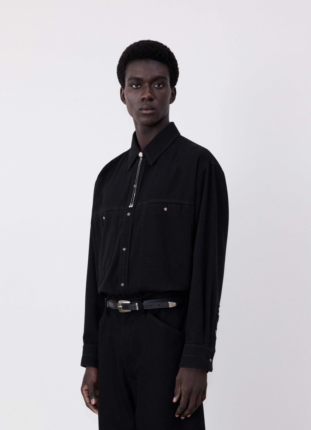 Lemaire judo pants in heavy yarn dyed black denim, model shot, side view high waist, tapered leg