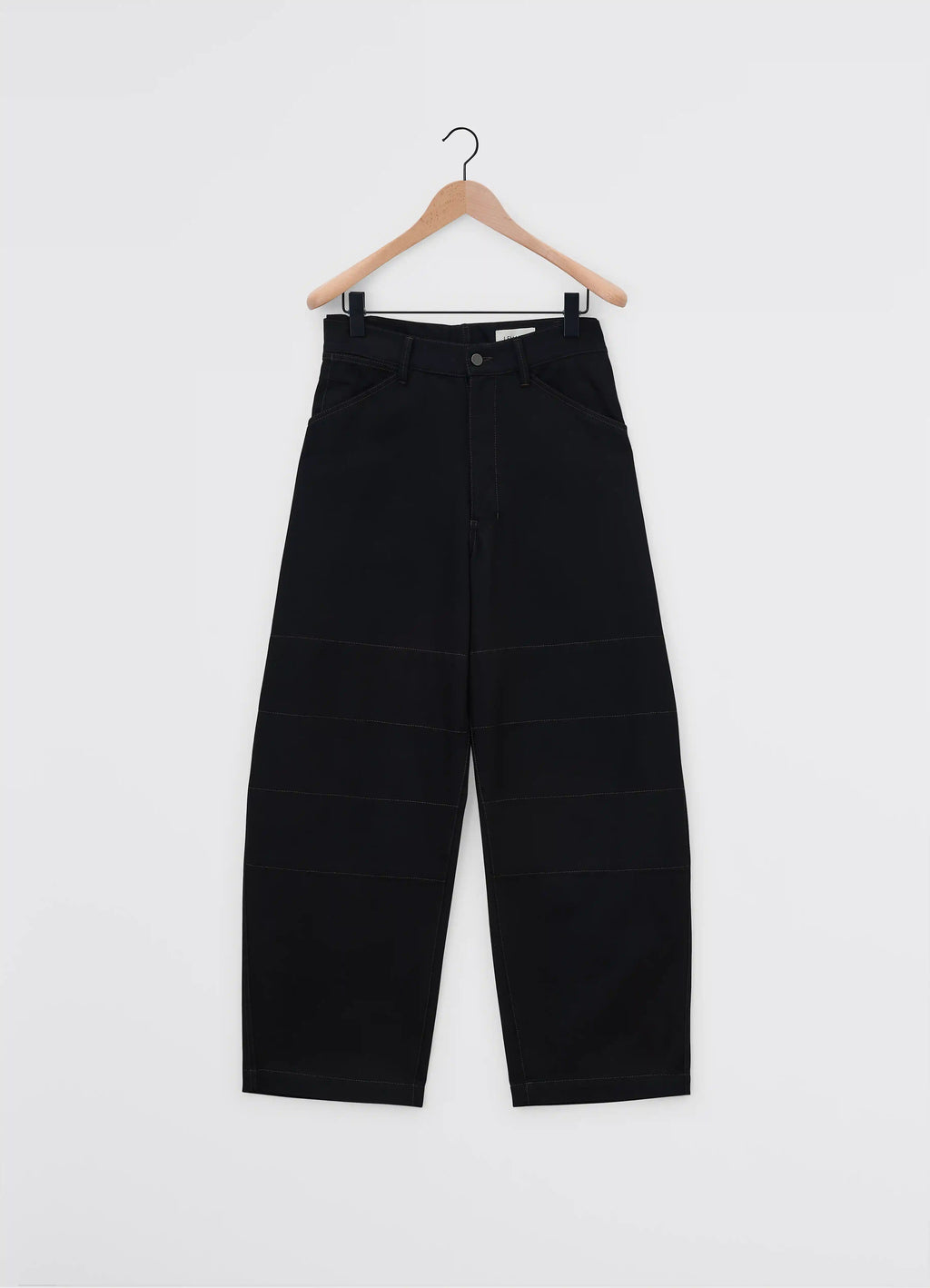 Lemaire judo pants in heavy yarn dyed black denim, product shot, hanging view structured waistband