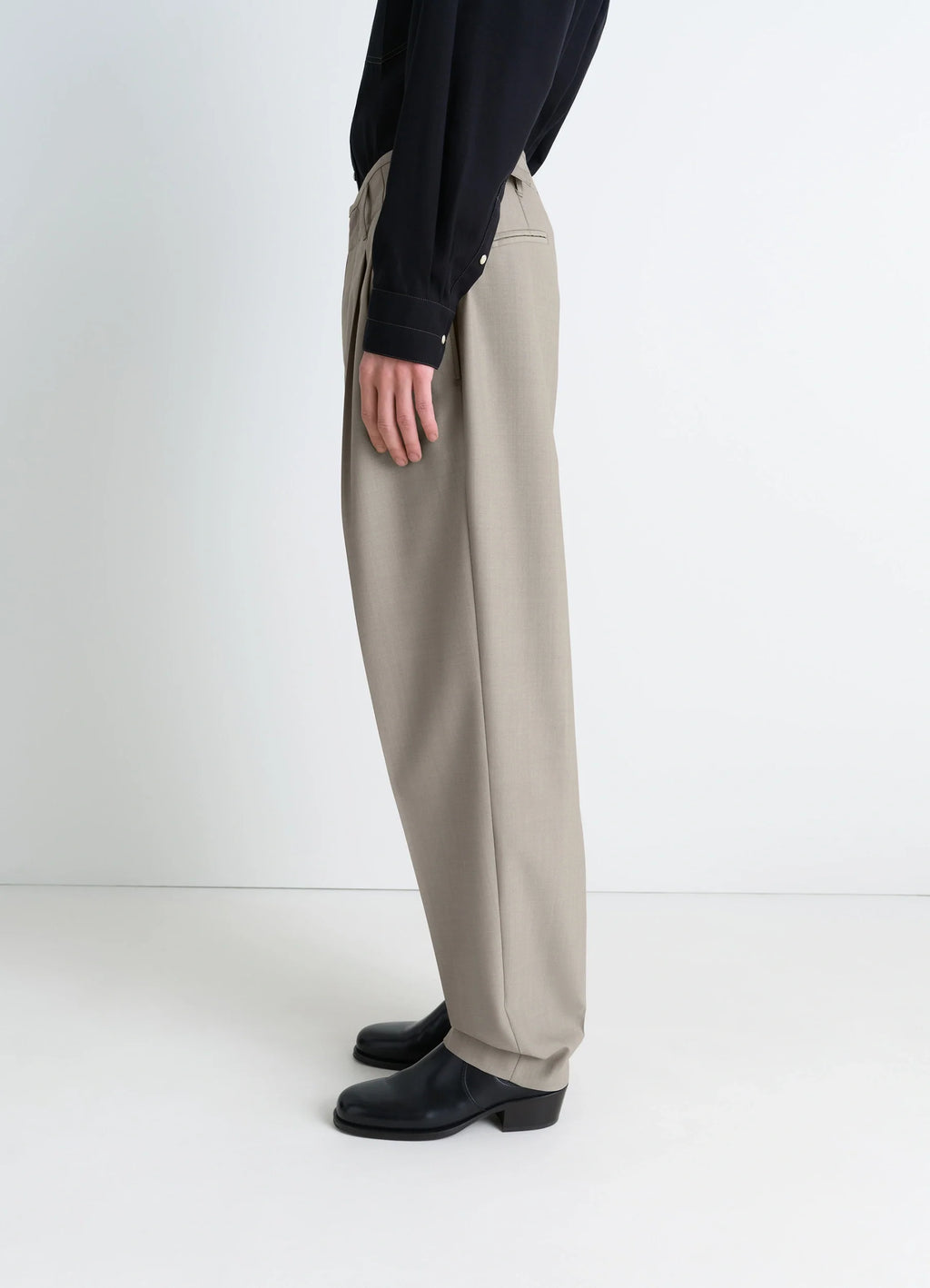 Lemaire pleated pants in tropical wool-blend suiting, model shot, profile view straight leg