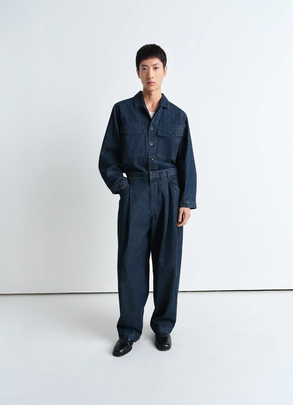 Lemaire Pleated Workwear Pants in Deep Indigo Heavy Denim, model shot, Front view Relaxed tapered leg