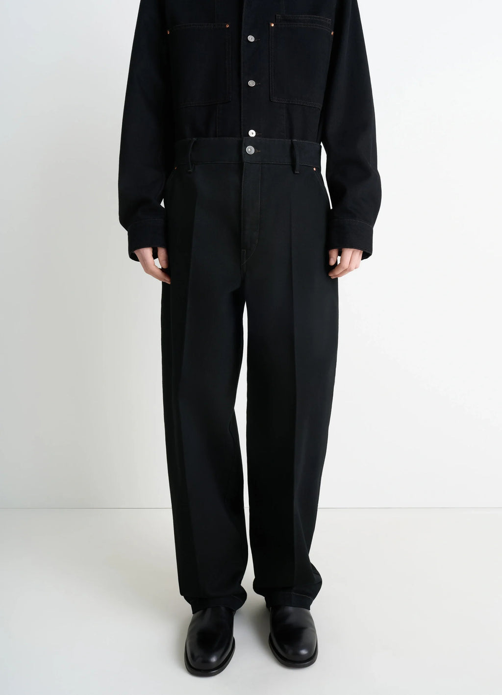 Lemaire maxi barrel workwear pants in deep black thick denim, model shot, front close up pleated wide leg