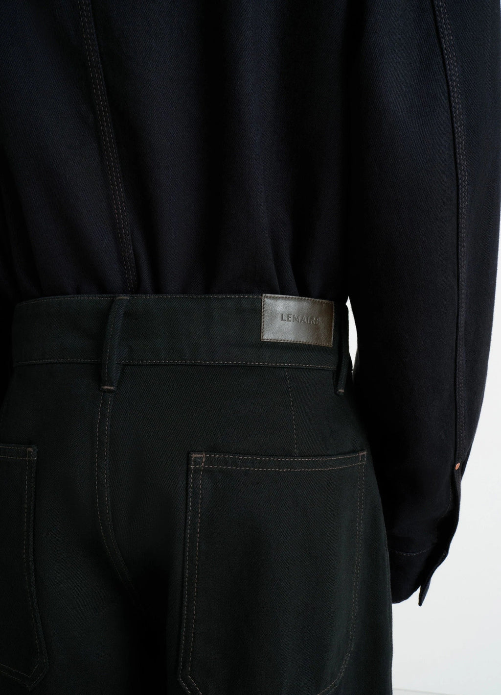 Lemaire maxi barrel workwear pants in deep black thick denim, model shot, back detail view belt loop with logo patch