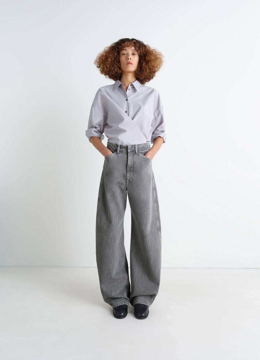 Lemaire high waisted curved pants in heather garment dyed snow denim, model shot, front view wide leg cut