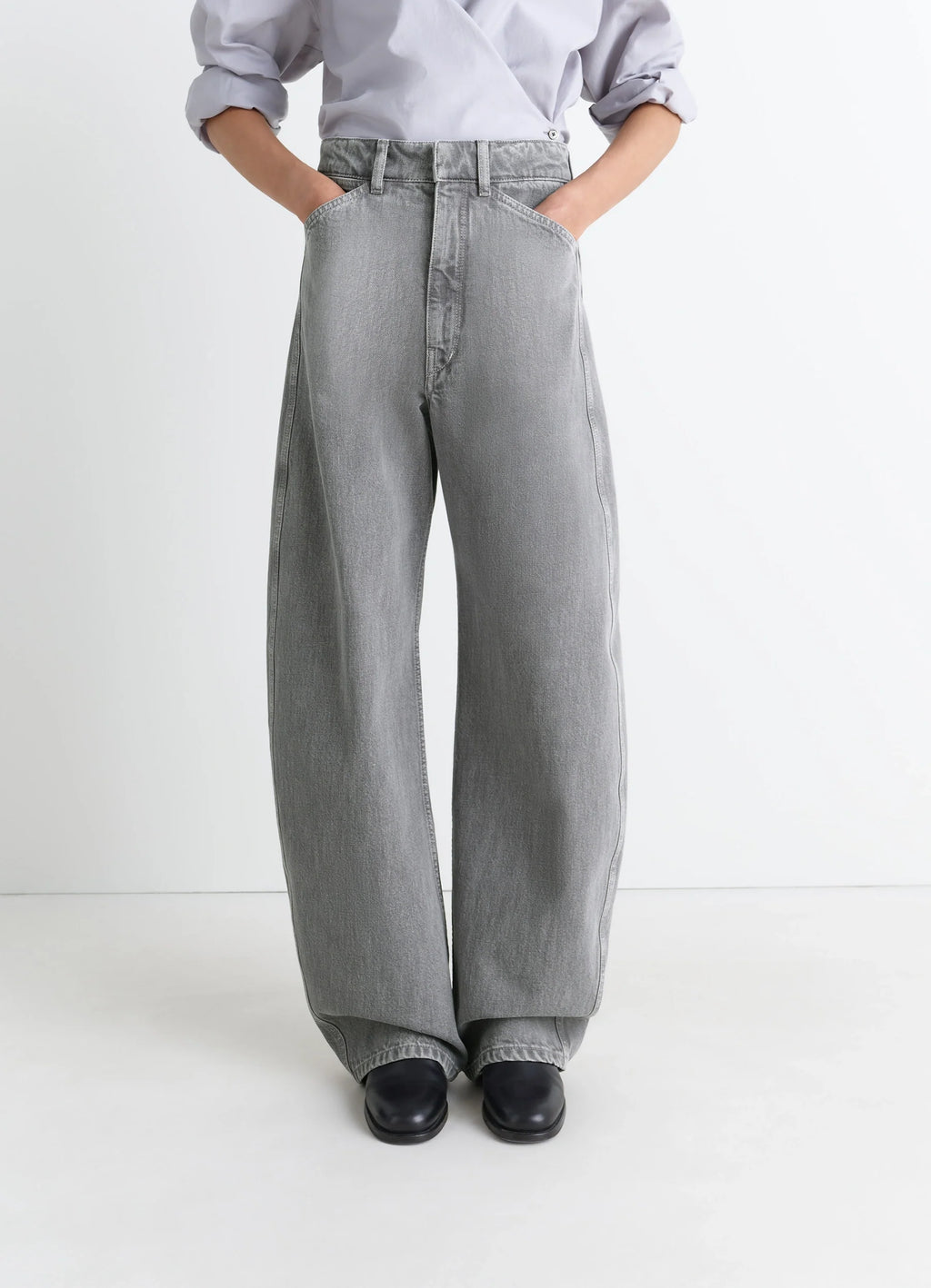 Lemaire high waisted curved pants in heather garment dyed snow denim, model shot, close-up view high waist wide leg