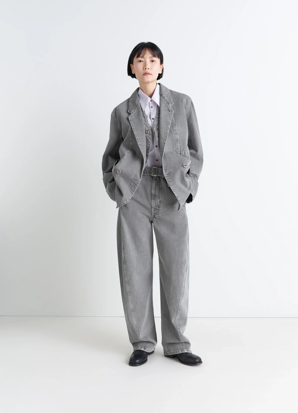 Lemaire twisted belted pants in snowy patina thick denim, model shot, side view loose fit