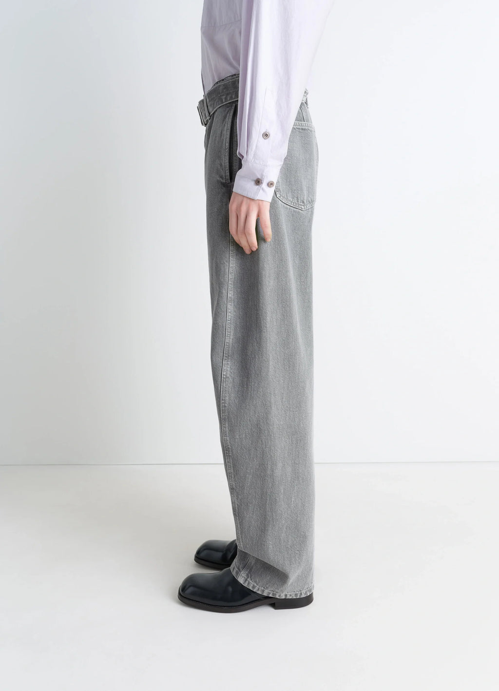 Lemaire twisted belted pants in snowy patina thick denim, model shot, left-side view straight leg profile