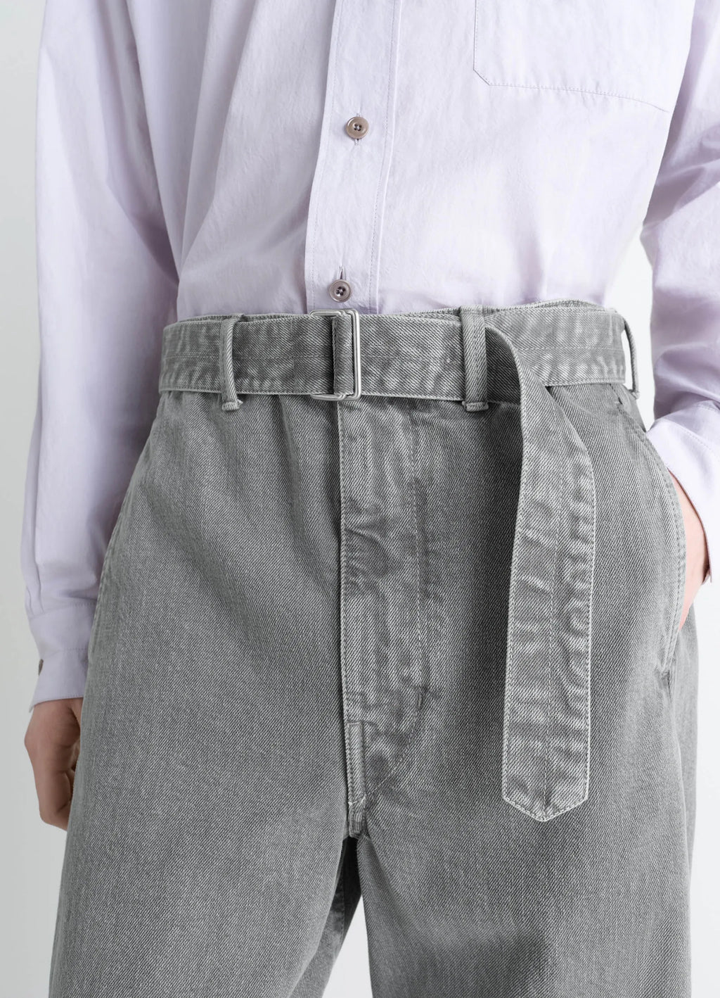 Lemaire twisted belted pants in snowy patina thick denim, model shot, waist-up close-up view belt detail visible