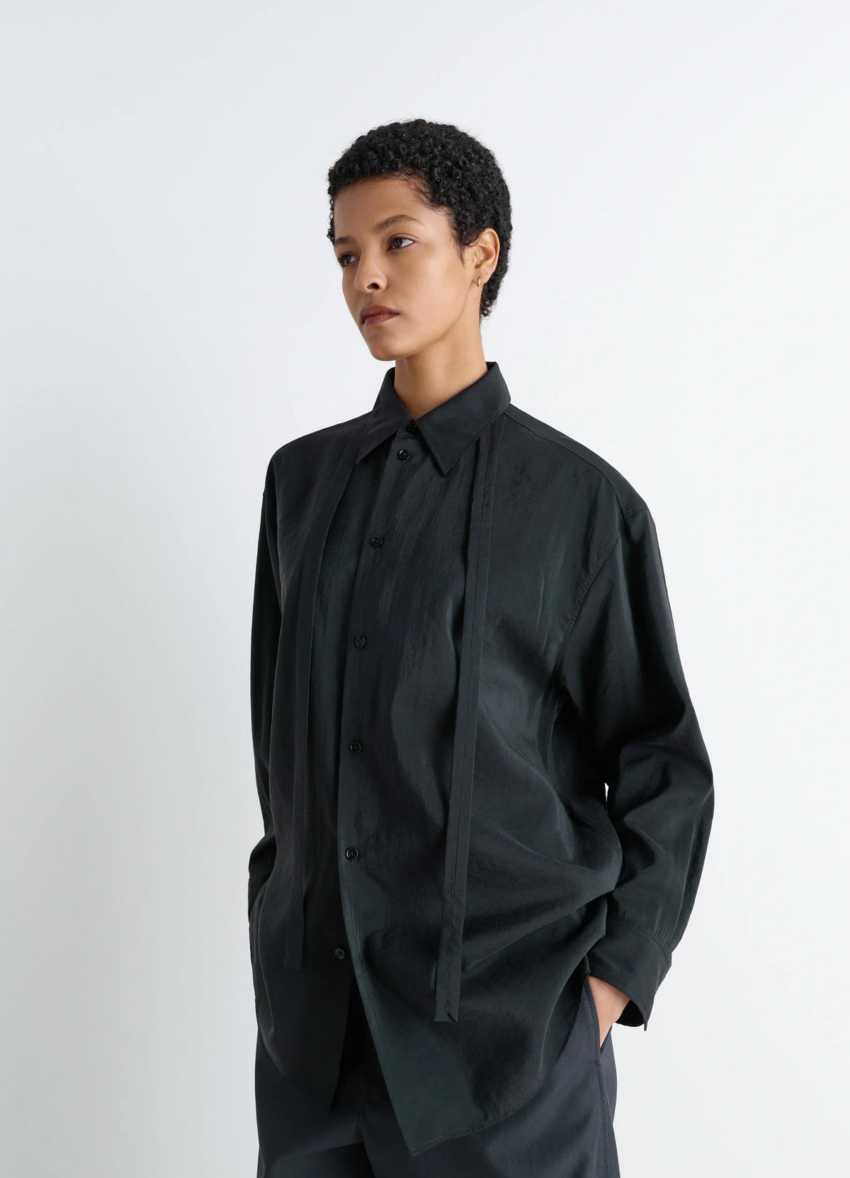 Lemaire Long Shirt with Tie in Black Dry Silk Blend, model shot, Three-quarter front view Oversized, necktie-style