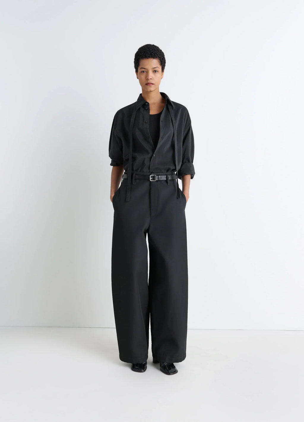 Lemaire long shirt with tie in black dry silk blend, model shot, front view rolled sleeves, relaxed fit