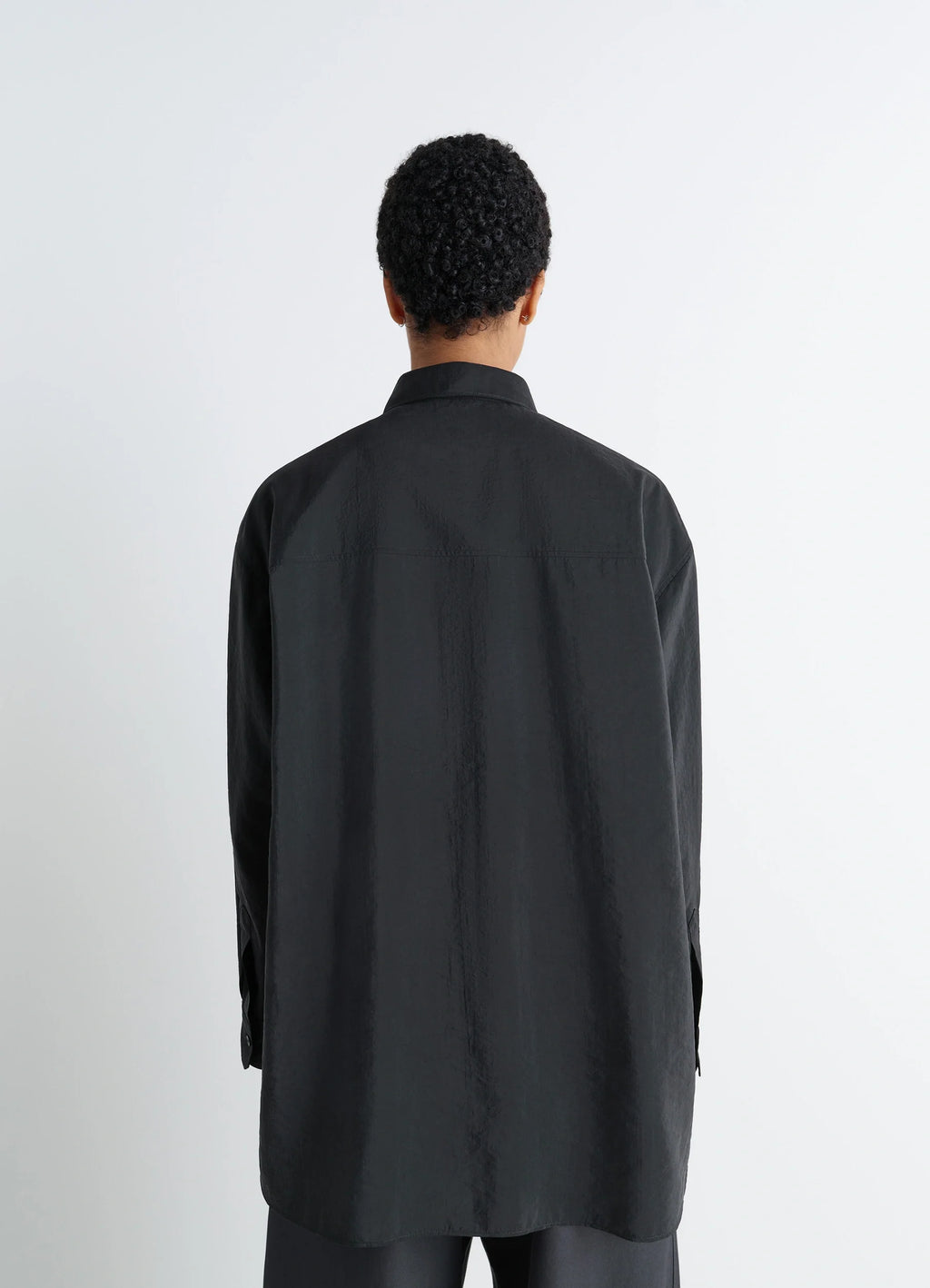 Lemaire long shirt with tie in black dry silk blend, model shot, back view straight hem untied
