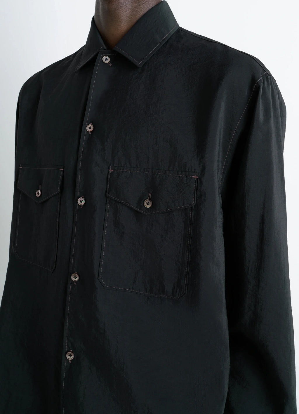 Lemaire convertible collar shirt in black dry silk blend, model shot, side chest detail patch pockets, textured silk