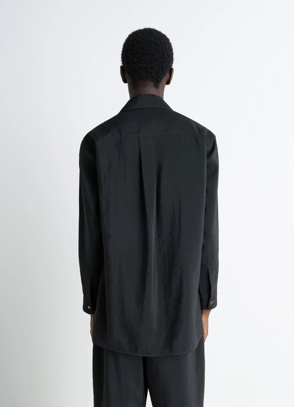 Lemaire convertible collar shirt in black dry silk blend, model shot, back view box pleat back yoke