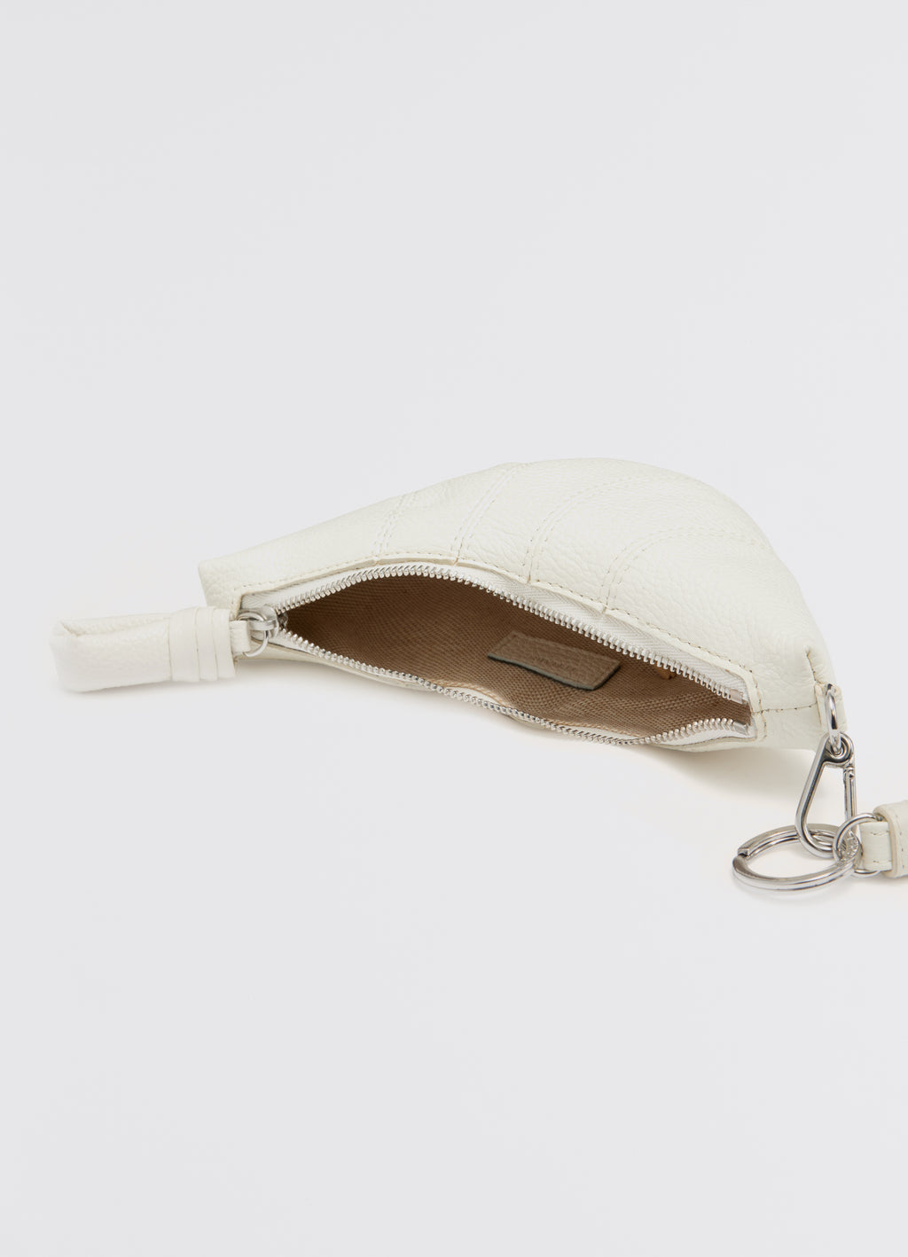 Cross-body croissant coin purse in soft grained leather, product shot, angled top view exposed zipper