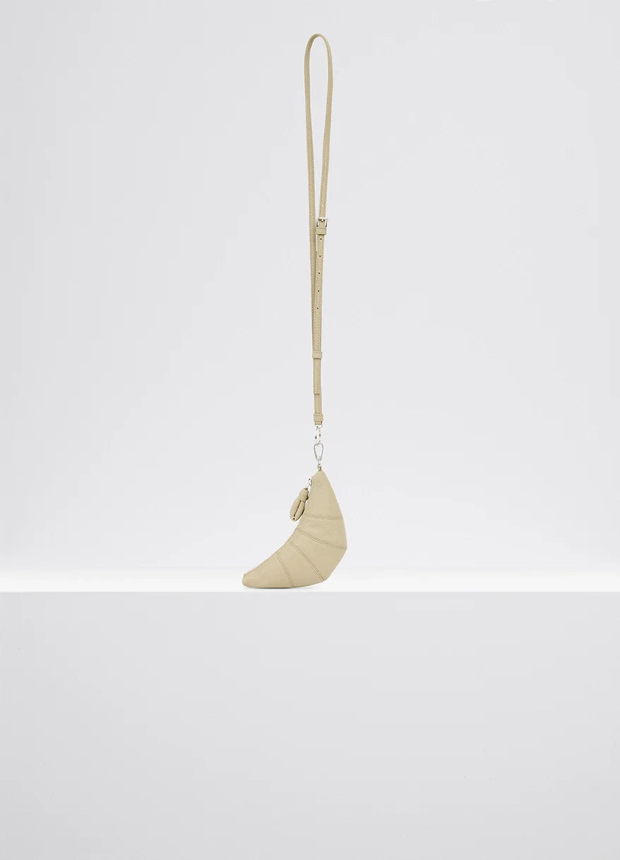 Cross-body croissant coin purse in soft grained leather, product shot, side view zipped compartment