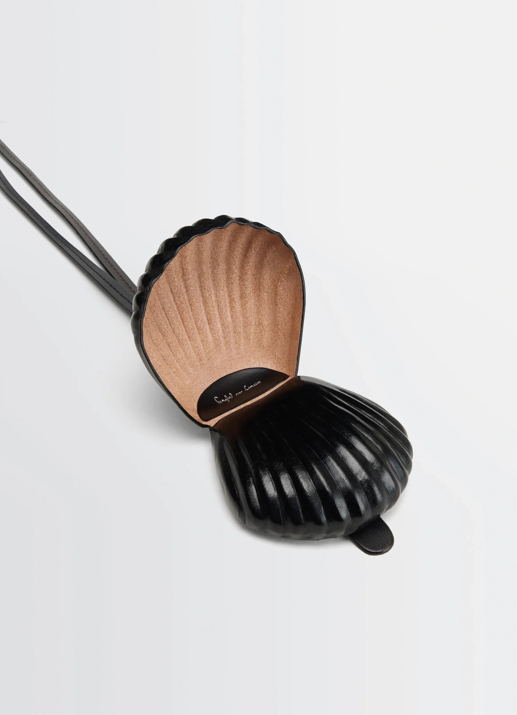 Carlos shell coin purse necklace in black vegetable-tanned leather, product shot, open shell top view texture detail inside
