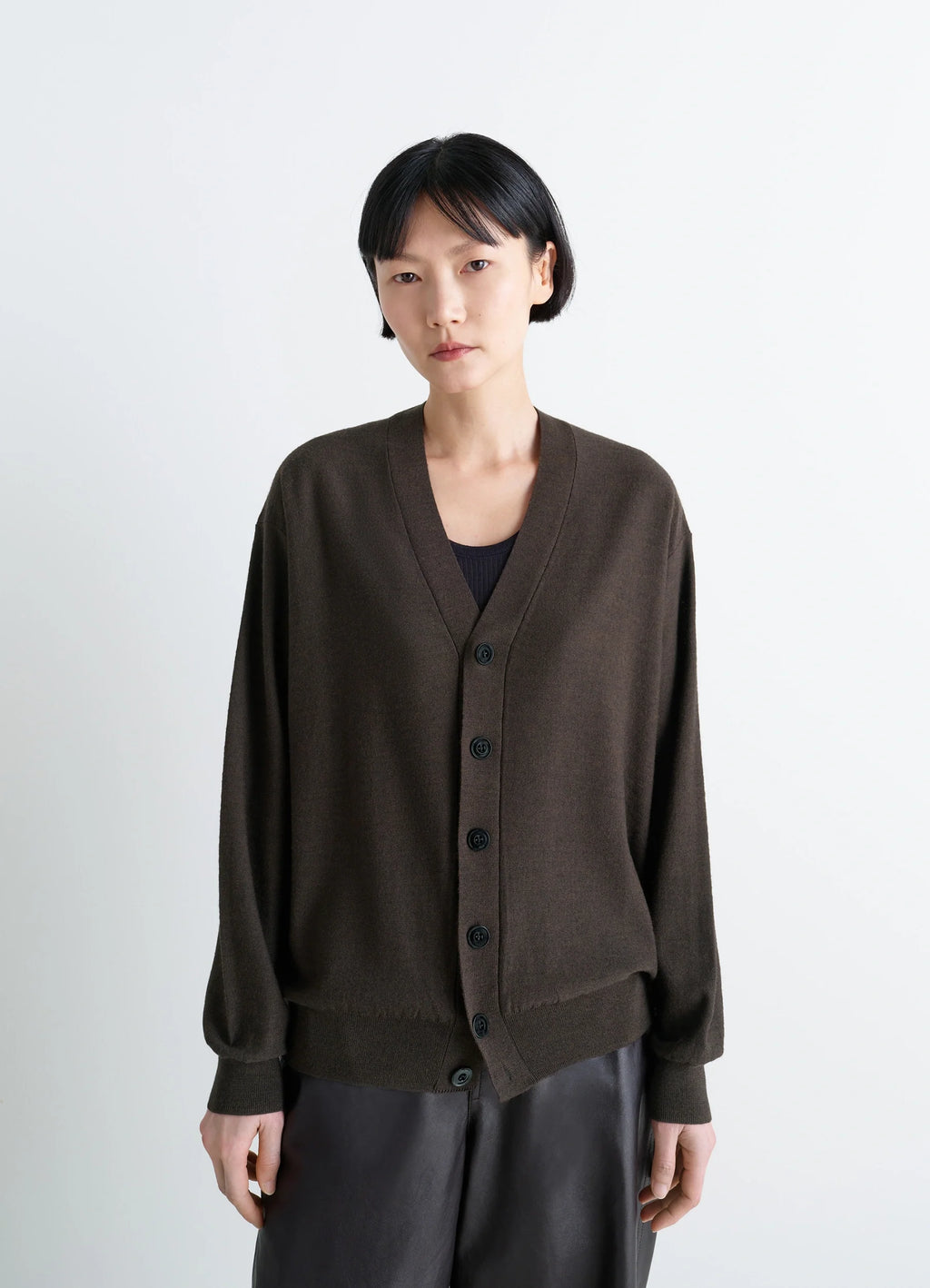 Lemaire relaxed twisted cardigan in knitted merino wool, model shot, three-quarter view dropped shoulders
