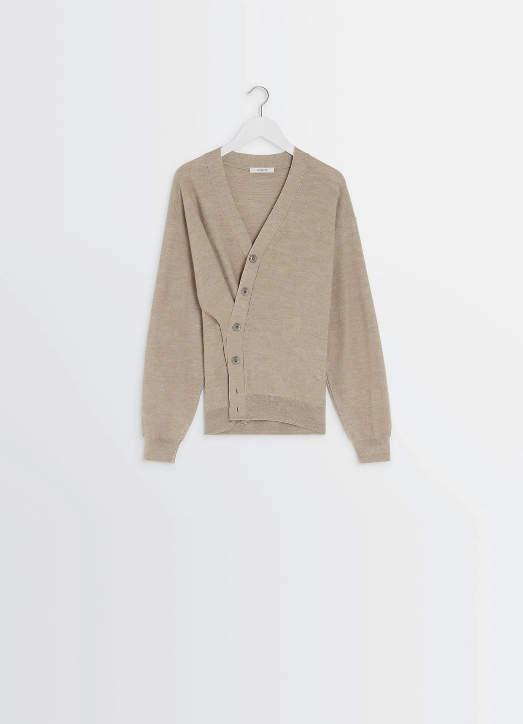 Lemaire relaxed twisted cardigan in light beige blended merino wool, product shot, angled overhead view overlapping button pl