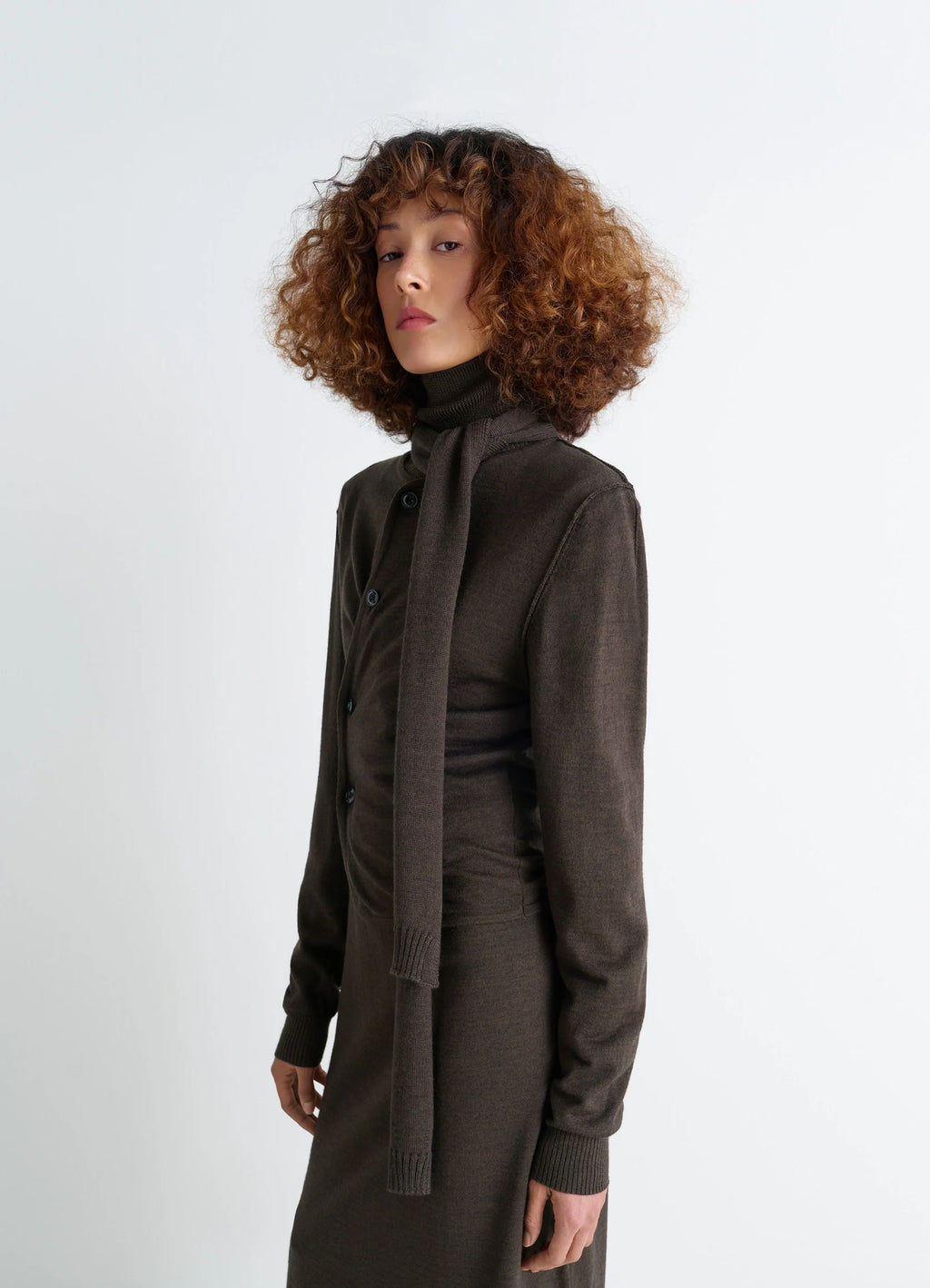Lemaire twisted cardigan in blended merino wool, model shot, side view asymmetrical placket