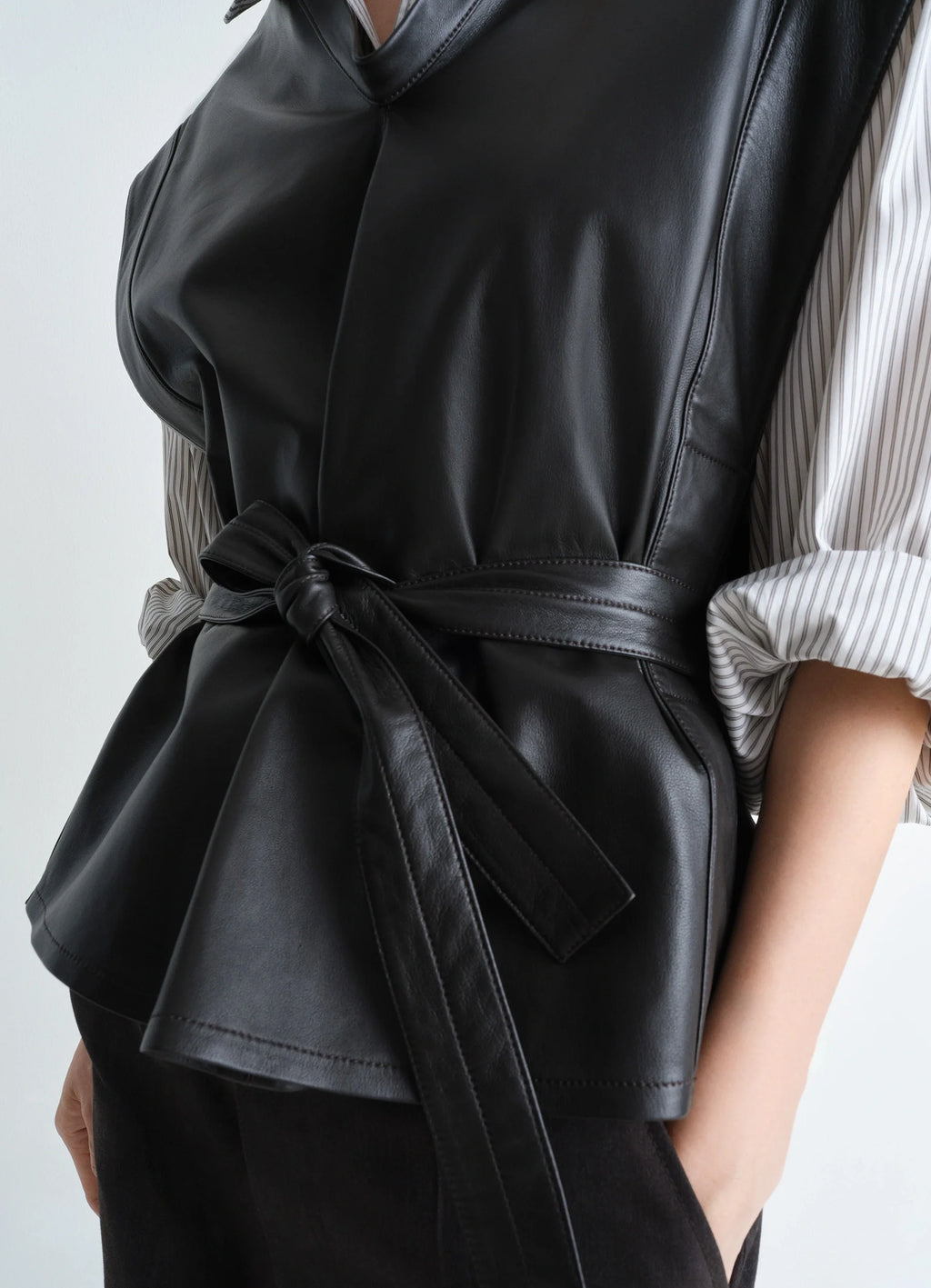 Lemaire leather chasuble in light lamb leather, model shot, side detail shot wrap belt with folds