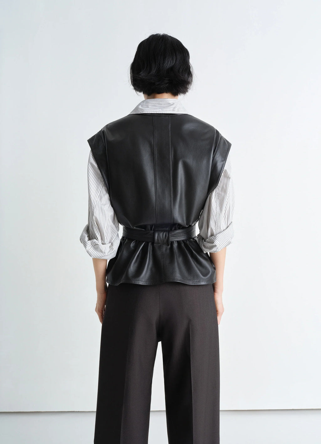 Lemaire leather chasuble in light lamb leather, model shot, back view belted pleated back