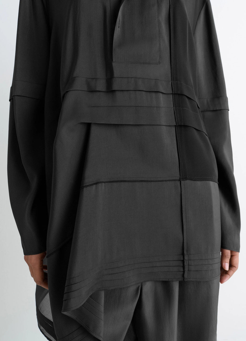 Blouse with pleats in black patchwork crepe de chine, model shot, back detail shot layered hem accent