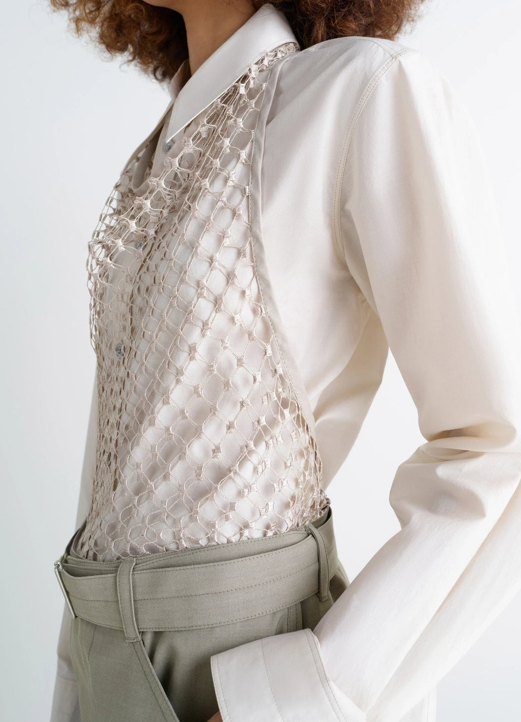 Lemaire fishnet halter top in cream fishnet, model shot, side view worn over long-sleeve shirt