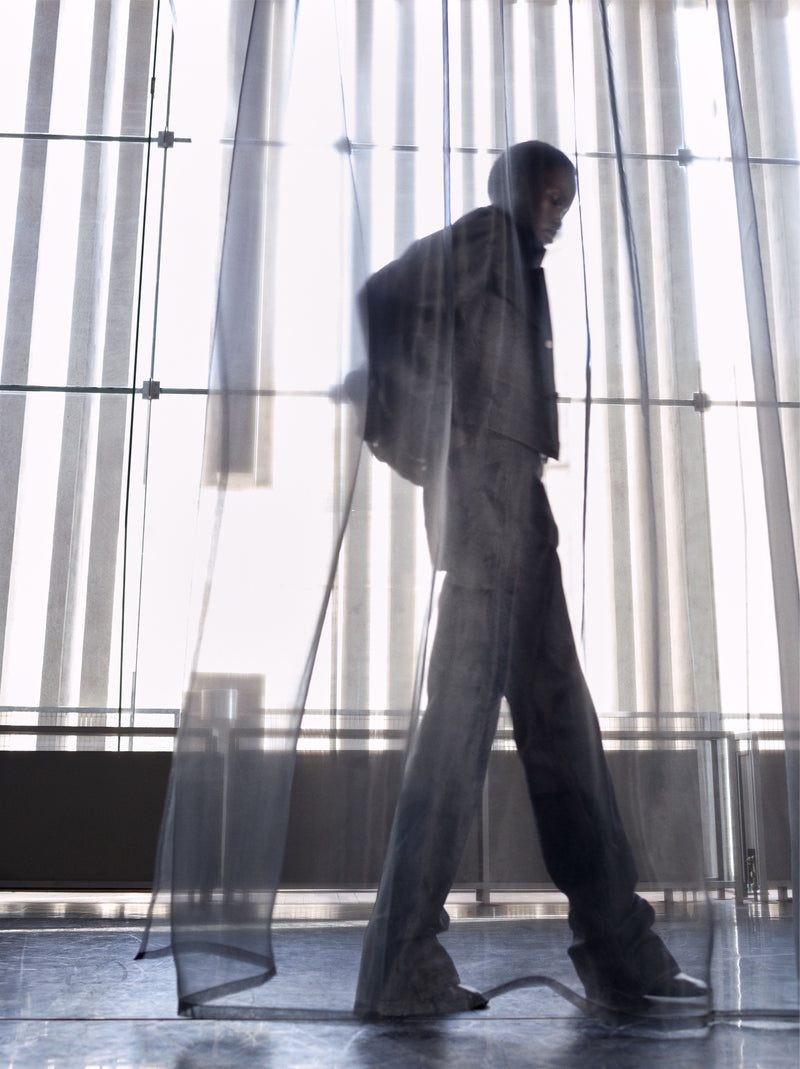 Black jacket and pants in Dark fabric, Side silhouette view Loose fit